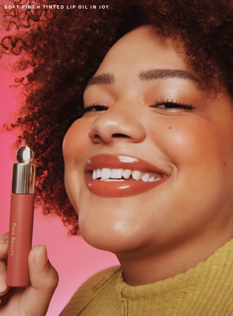 soft-pinch-tinted-lip-oil-on-figure-joy-03 Rare Beauty Soft Pinch Tinted Lip Oil - Joy